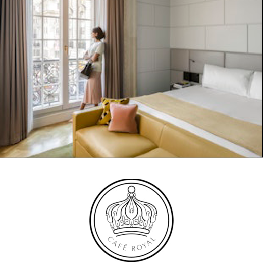 Café Royal. A woman stands beside the tall, sash windows of a Café Royal hotel room. The room is modern and chic and full of light.