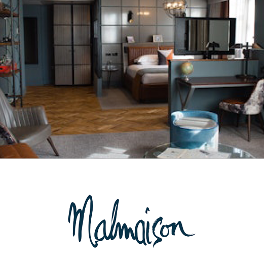 Malmaison. A vibrant boutique hotel room with an open planned layout including a lounge, desk and double bed.