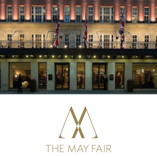 The May Fair. The front exterior of the May Fair hotel. The glamourous face of the Hotel from street level. Atmospheric lighting illuminates the buildings features.