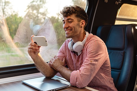 Man on train on his phone