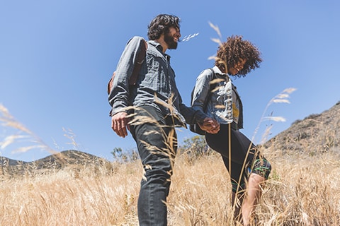 Two people walking through field