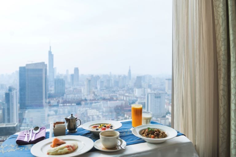 breakfast in hotel room with city skyline background,nanjing city,jiangsu province,china.