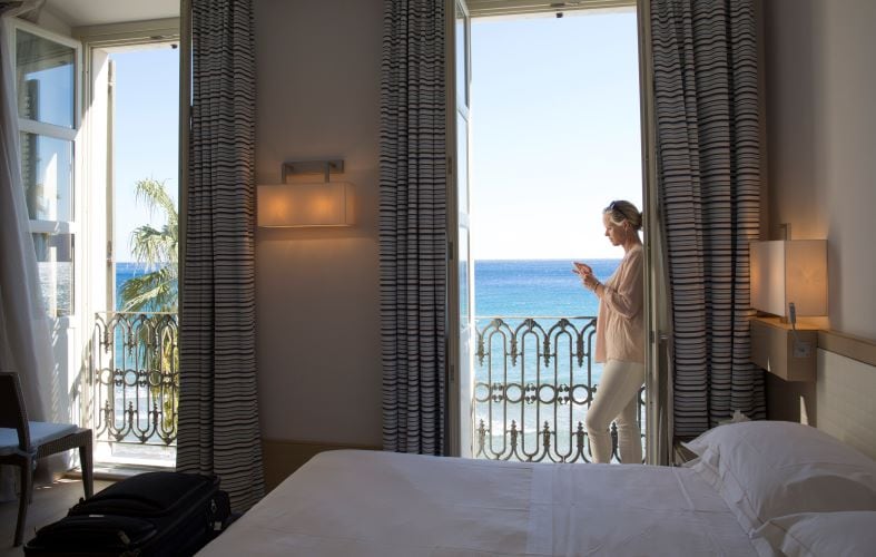 Woman standing on hotel balcony