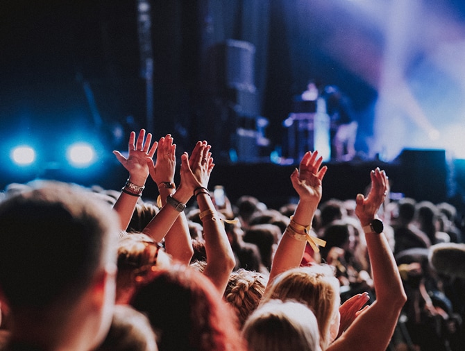 People at a concert with their hands in the air