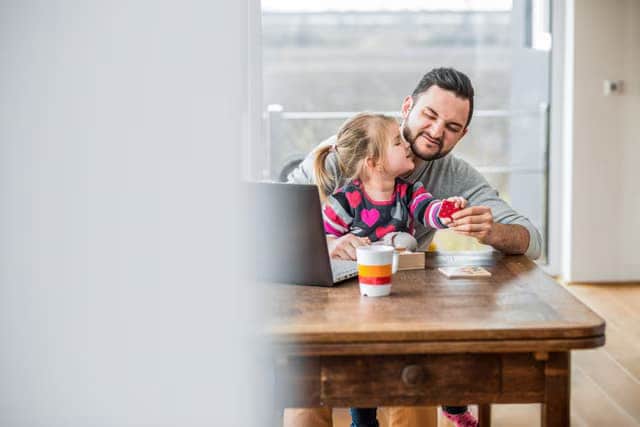 People smiling looking at a computer