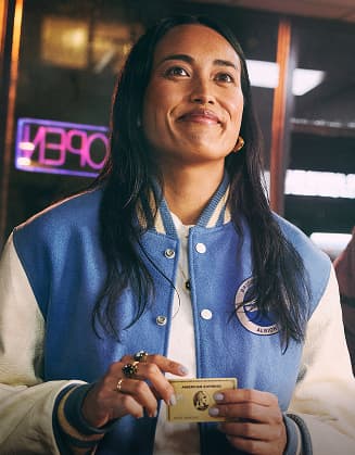 Person paying at restaurant counter with Amex Gold Card