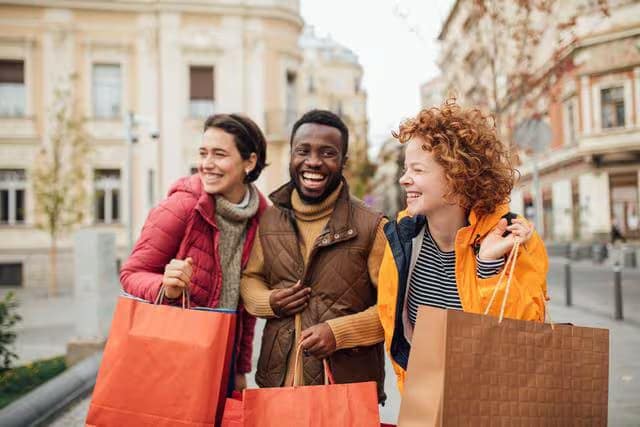 People smiling with shopping bags