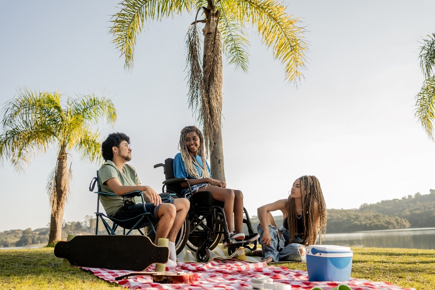 Group of friends enjoying summer vacation in a park