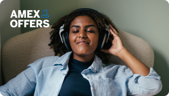 Amex Offers image alt text: Woman smiling listening to music on her headphones, Amex Offers logo in the top left corner