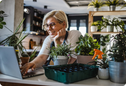 Two colleagues looking at a laptop together smiling