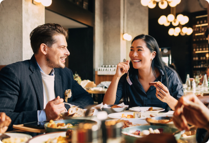 Work friends eating in a nice restaurant looking happy