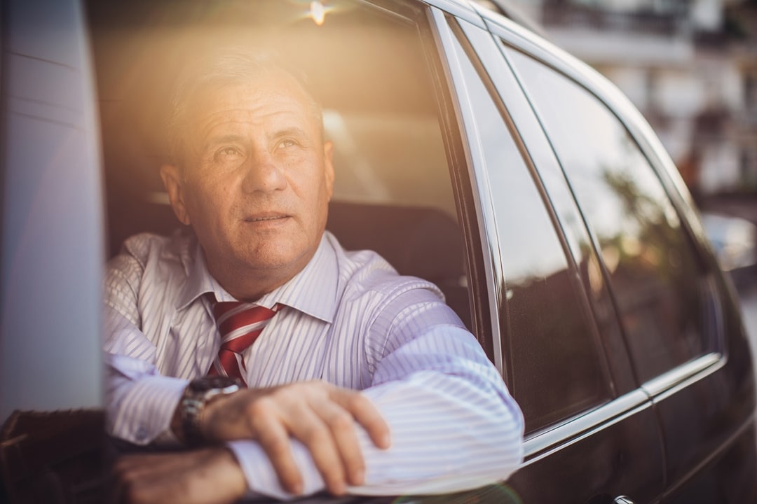 Man sitting in a car looking out of the window