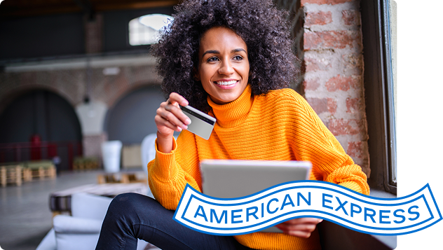 Person looks at a tablet while holding a credit card