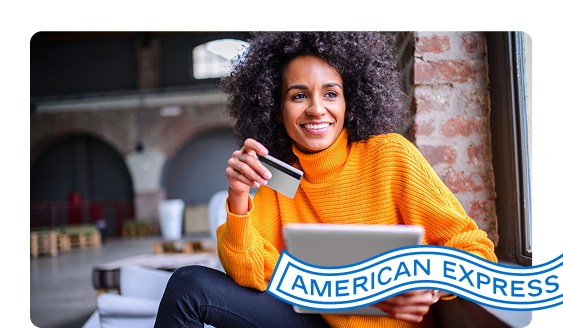 Person looks at a tablet while holding a credit card