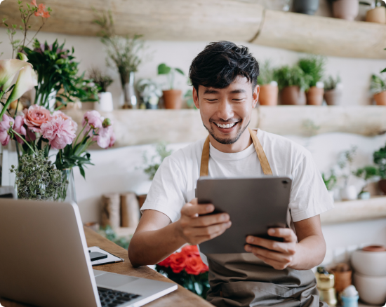 Person looks at tablet in a flower shop
