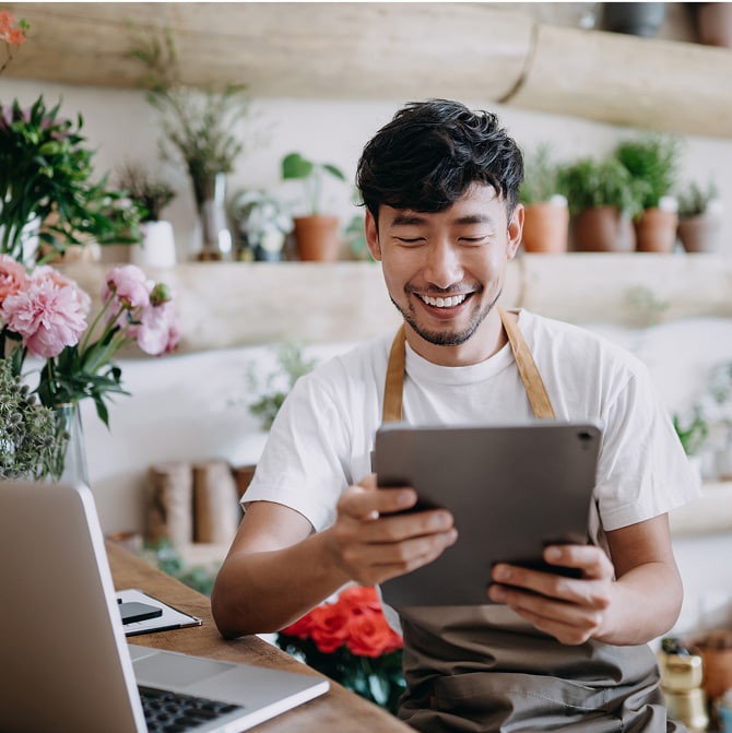 Person looks at tablet in a flower shop