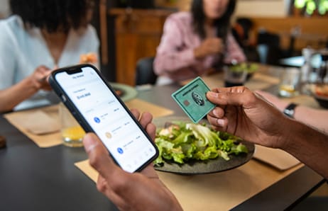 Person pays for a meal in a restaurant