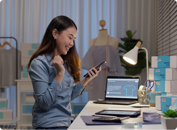 Person looks at phone while sitting at desk