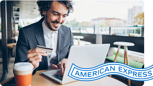 Person sits and looks at laptop with Card in hand