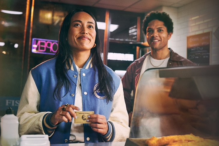 Person paying at restaurant with Amerian Express Gold Credit Card