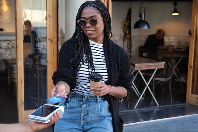 Woman using a credit card to buy.