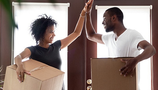 A couple giving each other a high-five during the move in process