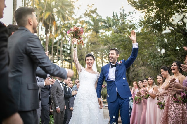 Confetti throwing on happy newlywed couple.