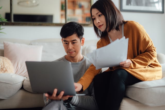 Couple going through their paperwork together at home.