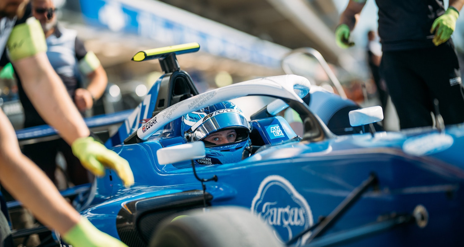 A woman driving a Formula 1 car at the F1 ACADEMY.