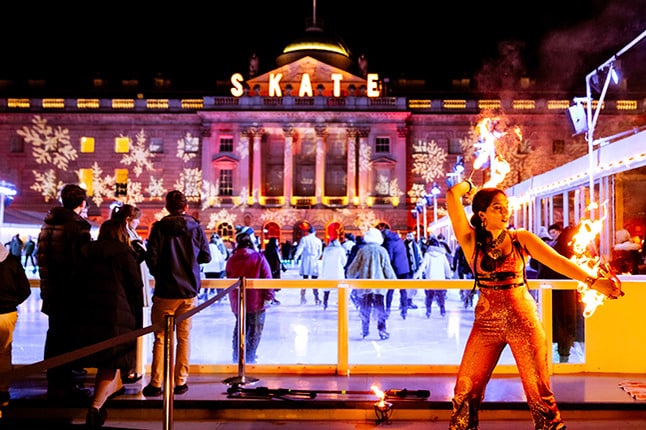A fire dancer at the skate rink in Somerset House's courtyard