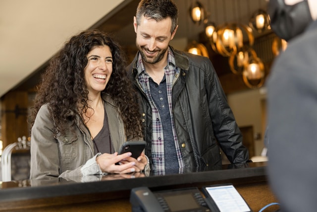 Couple checking in at hotel reception.