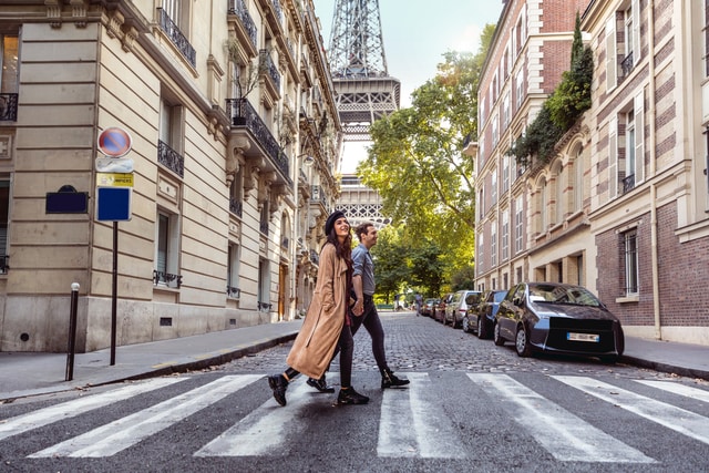 A couple walking through the streets of Paris.