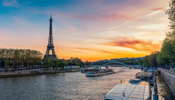 A view of the river Seine and the Eiffel Tower in Paris at sunset.