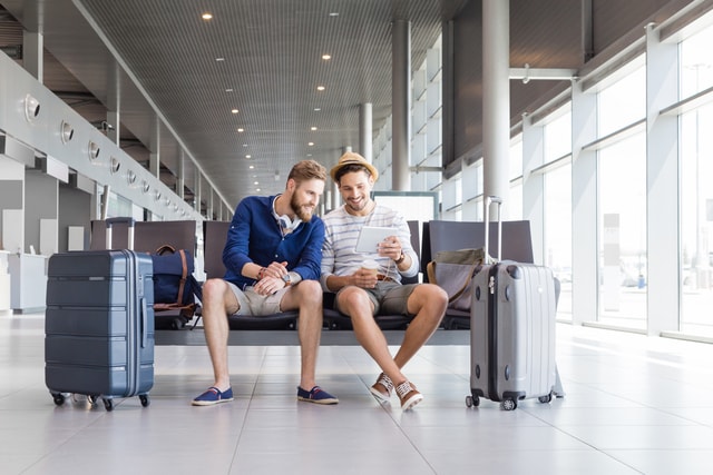 Couple waiting for a flight at an airport terminal.