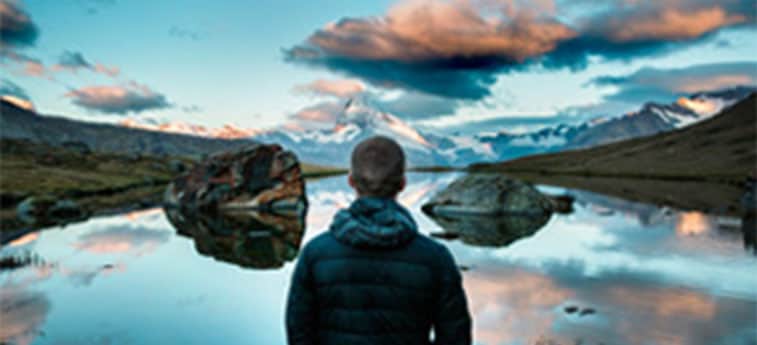 two women and a man overlooking a scenic ridge