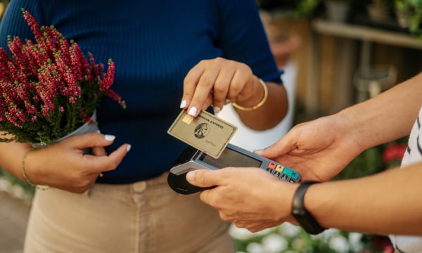 Woman paying at terminal with American Express card