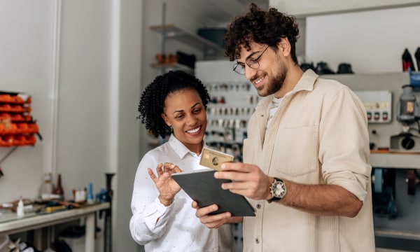 Small business owners looking at tablet device