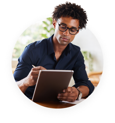 Person with Glasses Looking at their Tablet