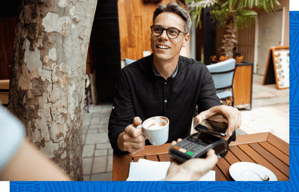 A man earning rewards as he uses Google Pay to pay for coffee.