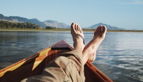 Person relaxing on boat in water