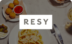background of pasta dish with utensils with Resy logo overlaid 