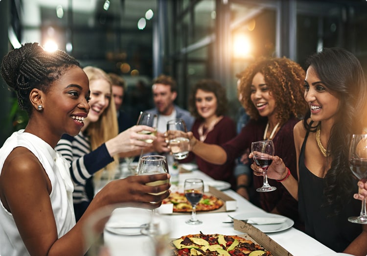 Group of friends at a long table eating