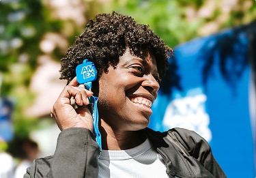 Fan putting an American Express branded radio to his ear