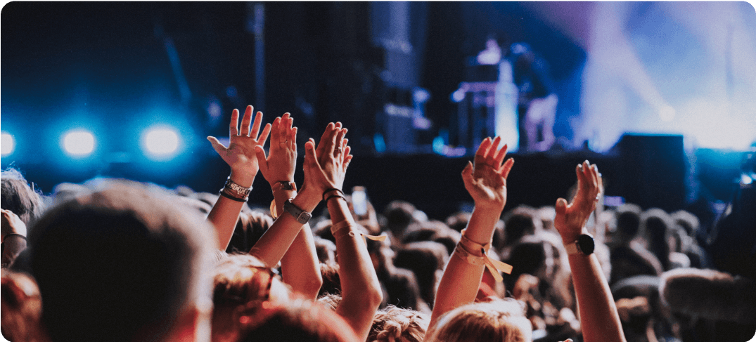 People in a crowd with raised hands