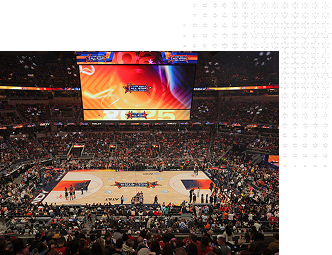 Wide shot of interior of basketball arena surrounded by fans