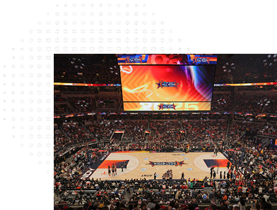 Wide shot of interior of basketball arena surrounded by fans