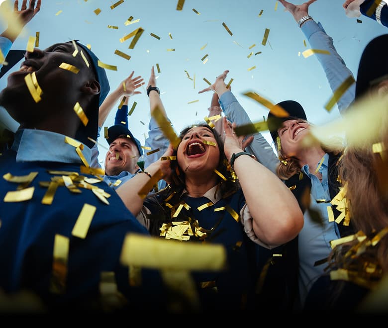 crowd of people cheering with confetti in the air