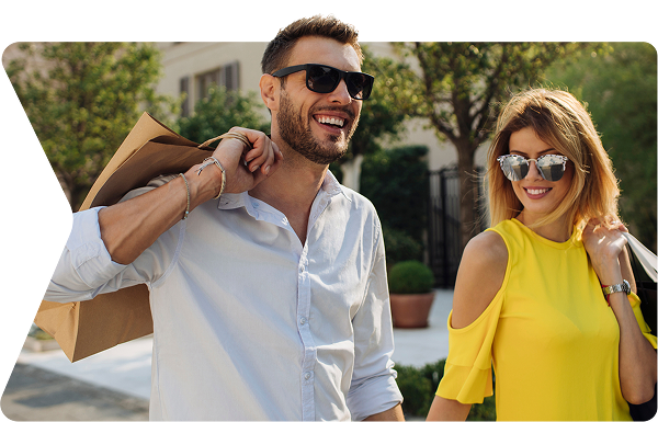Man and woman smiling shopping together, walking on the street