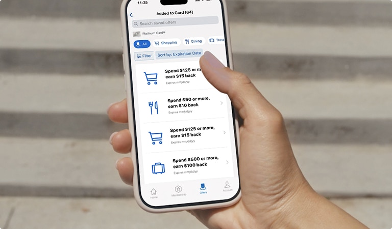 Person scrolling through mobile device viewing Amex Offers and Benefits