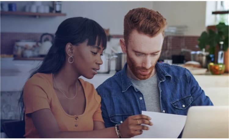Couple reviewing paperwork at kitchen table